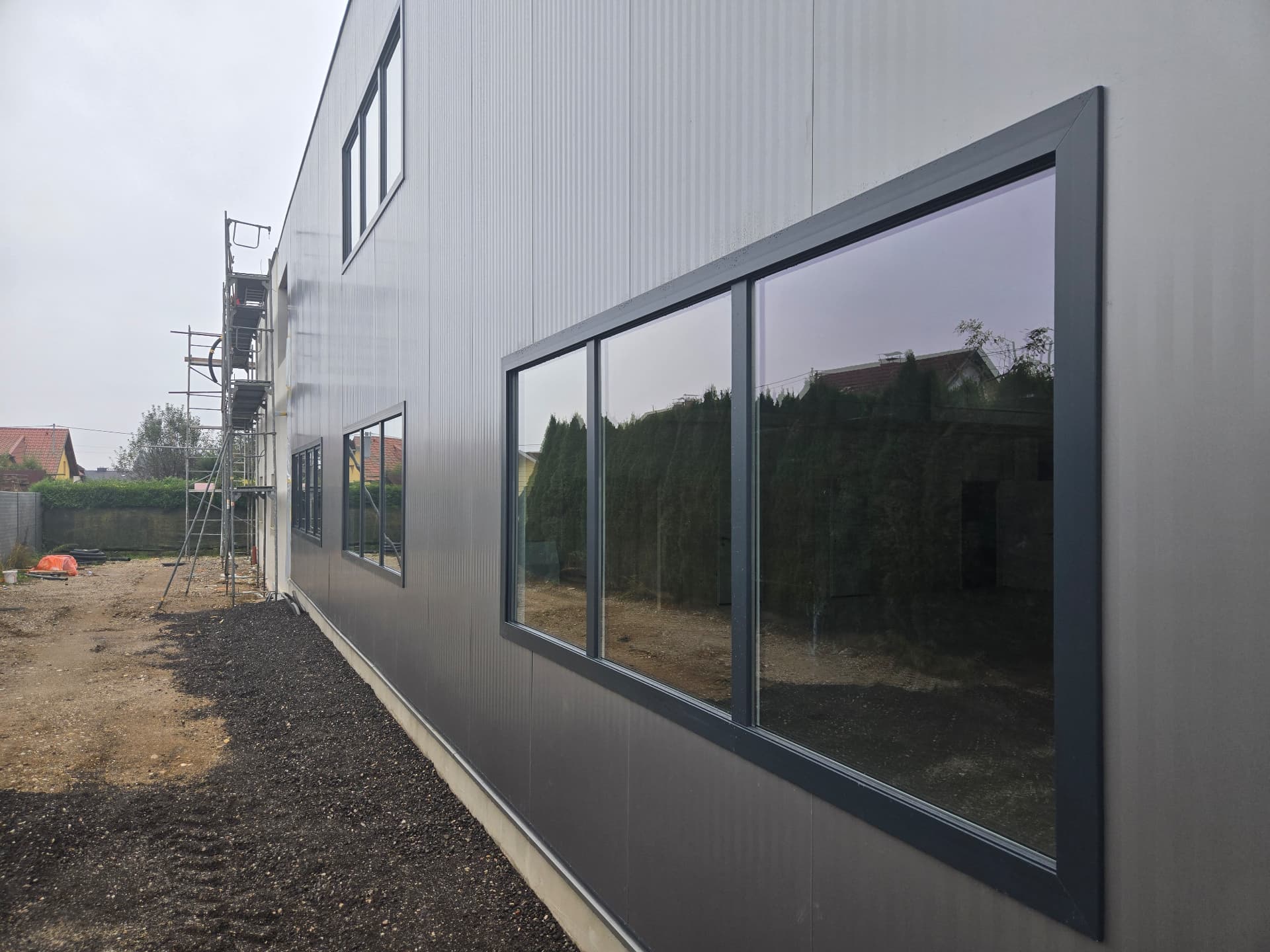Industrial building with sandwich-panel façade and integrated windows — 4