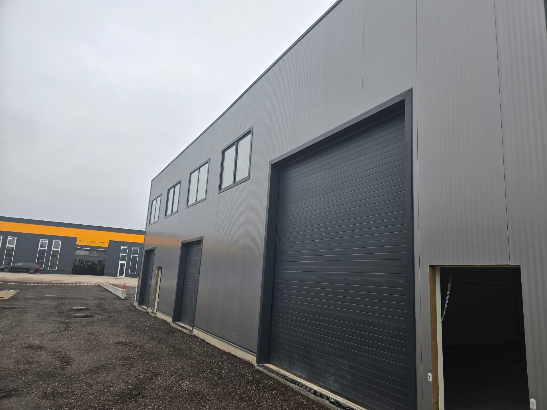Industrial building with sandwich-panel façade and integrated windows — 2