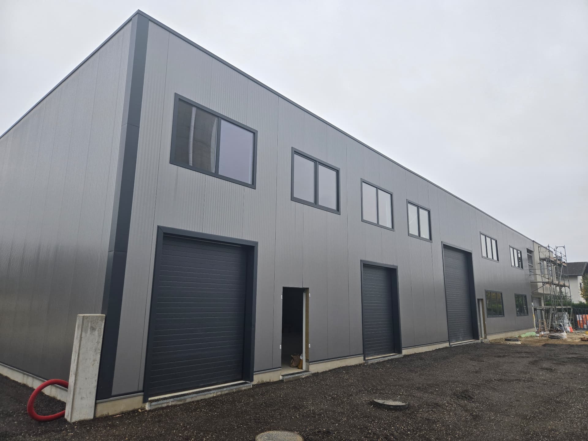 Industrial building with sandwich-panel façade and integrated windows — 5